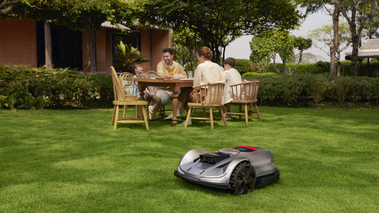 Sunseeker Elite X7 mower and a family having lunc