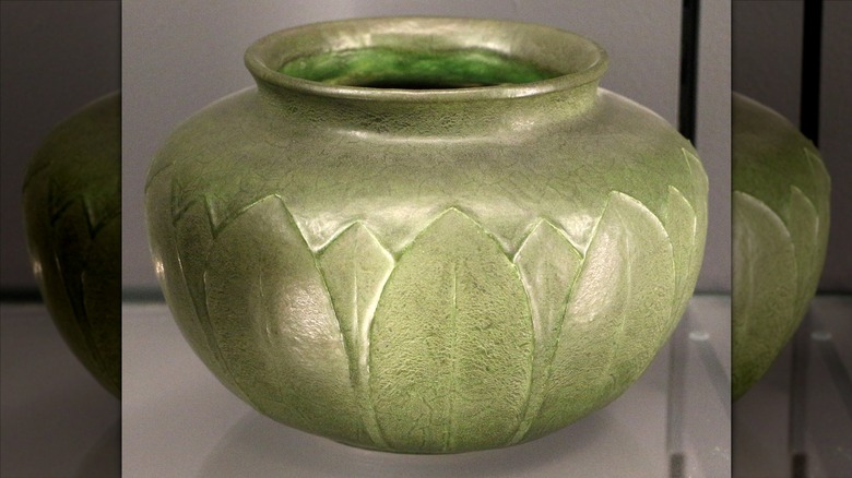 A matte green Grueby vase pottery piece that is valuable