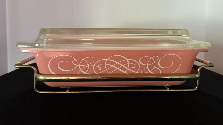 The Pyrex Pink Scroll serving dish with clear lid and metal cradle
