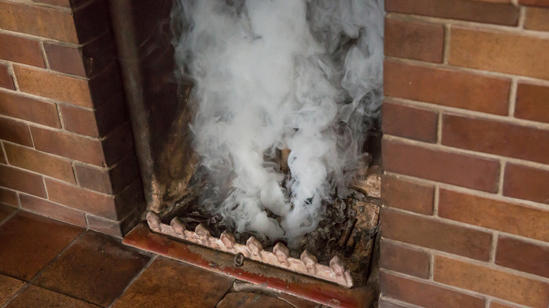Smoke leaking out of a fireplace