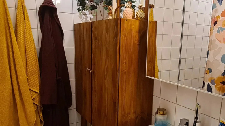 IKEA IVAR cabinet stained and raised on legs in a small bathroom