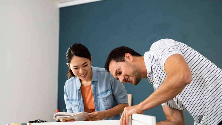 Couple working on a piece of furniture