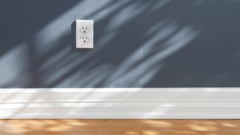 bright white outlet against lovely blue painted wall