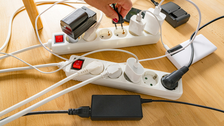 Wires and cords plugged into power bars.