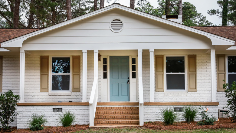 white ranch home with landscaping