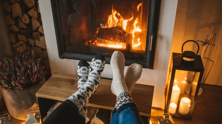 feet at wood-burning stove