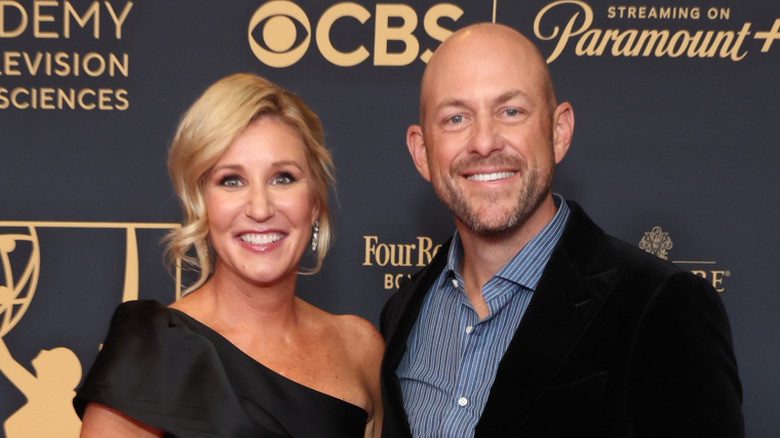 Jenny and Dave Marrs standing together at red carpet event and smiling