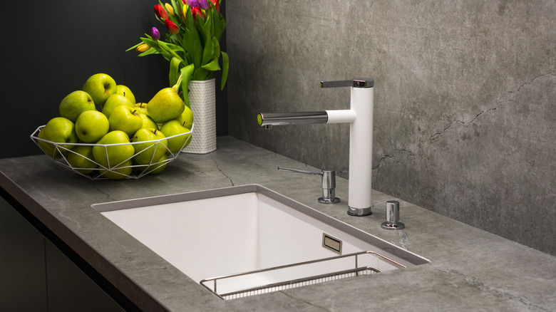 an industrialist kitchen with concrete walls and countertops