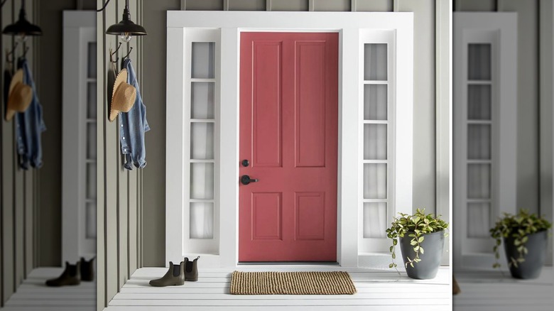Red front door painted in Magnolia's Vine Ripened Tomato against white porch