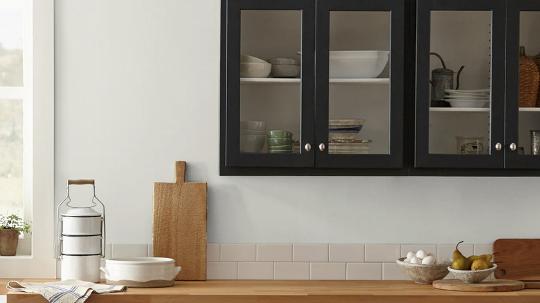 Walls in kitchen painted Magnolia's Shiplap with black cabinets