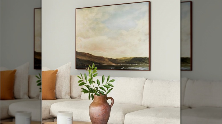Living room wall painted in Blanched by Magnolia with artwork and couch