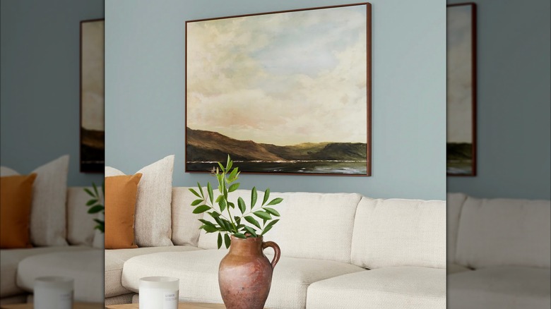 Living room wall painted in Rainy Days by Magnolia with artwork and couch