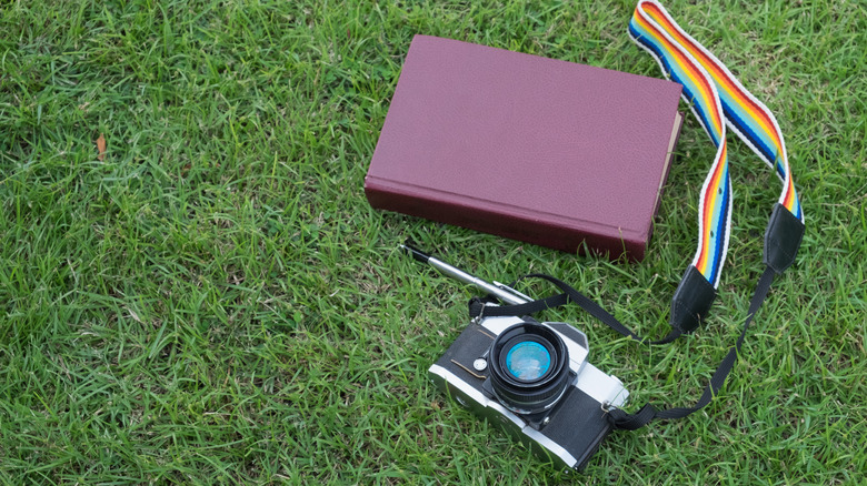 camera, pen, and notebook