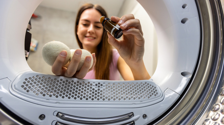 Woman adding essential oils to dryer balls