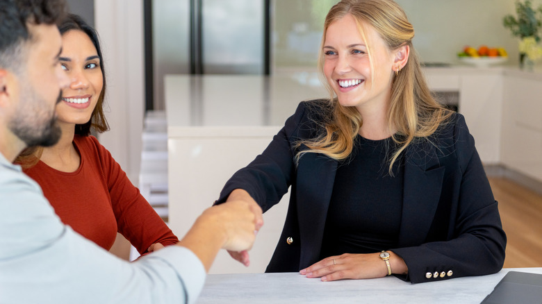 Homeowners meet with insurance agent.