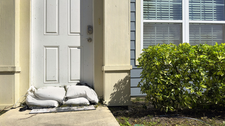 Sandbags piled against the door of residential building