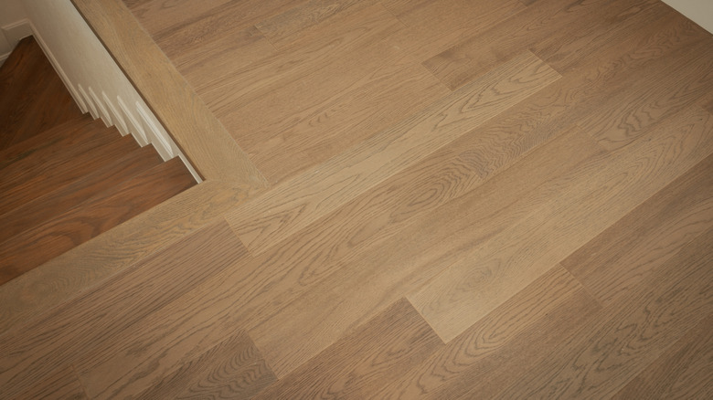 Top-down view of a stairwell and landing with wooden flooring