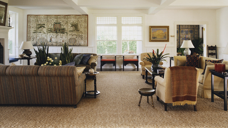 A carpet in a living room with subtle patterns achieved by using different pile heights and adjacent colors