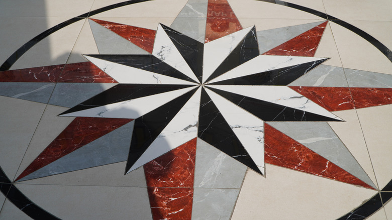 Compass tile mosaic on floor