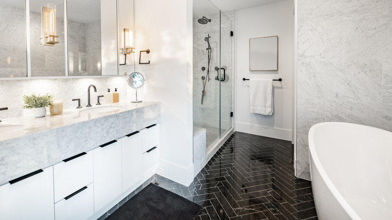 White bathroom with black floor tile