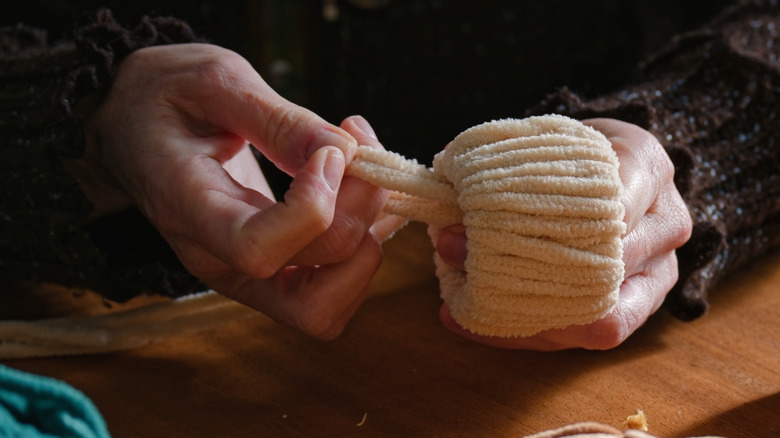 Hands working with fluffy yarn
