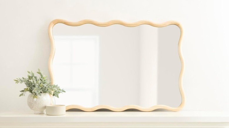 Kate and Laurel wavy mirror on a mantel