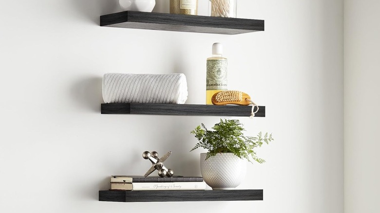 Espresso wood floating shelves with classy bathroom decor