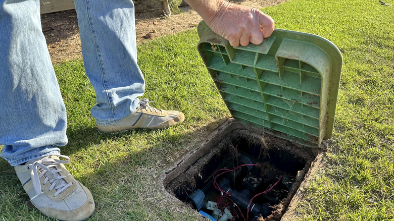 Lifting the hatch on the control box for a garden watering system