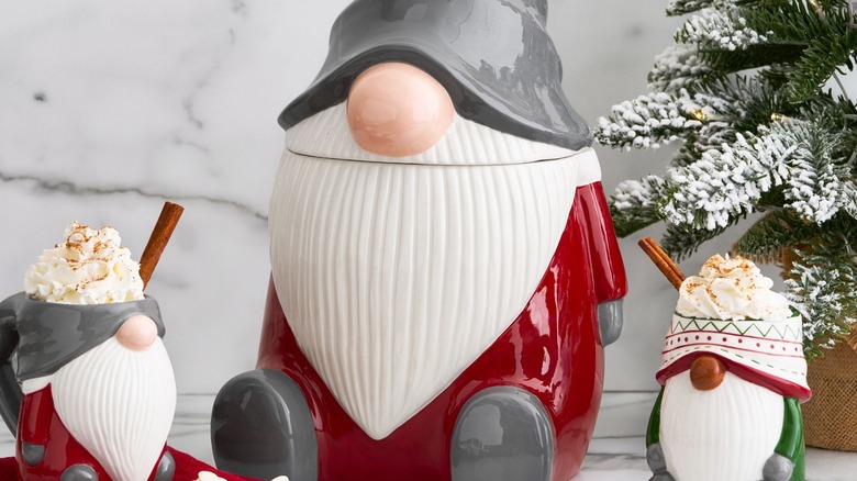 Pottery barn gnome cookie jar next to two mugs