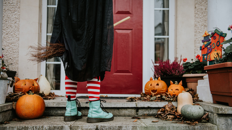 person standing near halloween decor