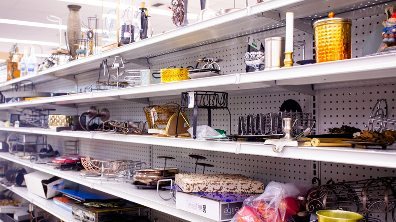 Assorted goods on metal shelves in a thrift store.
