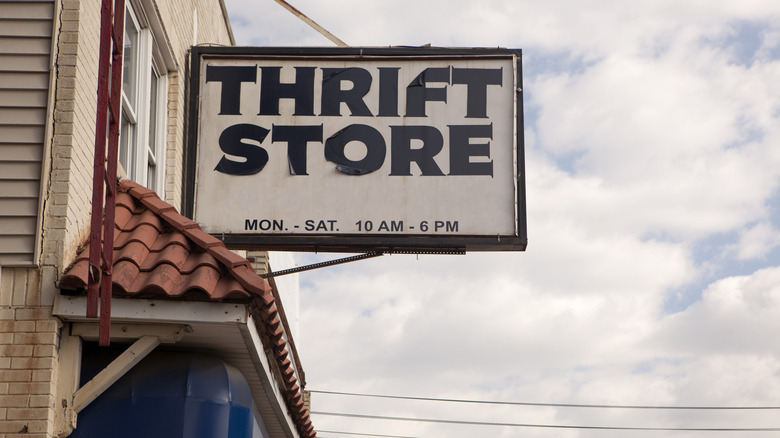Thrift store sign hanging from the outside of a store.
