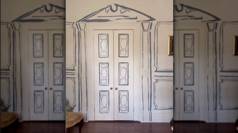 A door with a border and panels painted in a cartoonish outline