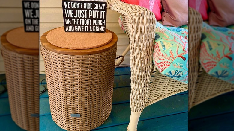 An Aldi Belavi Rattan Storage Table styled on a summery porch