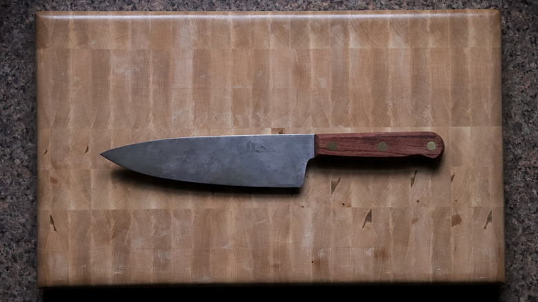 Carbon steel chef knife on a cutting board