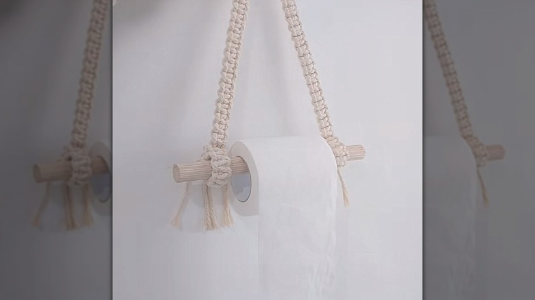 a macrame toilet paper holder with a distinct boho-chic style