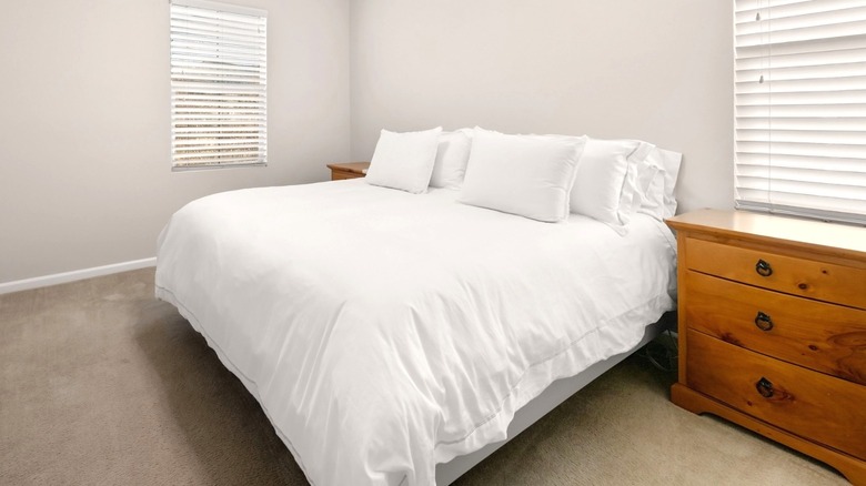 small bedroom with bed that has no headboard