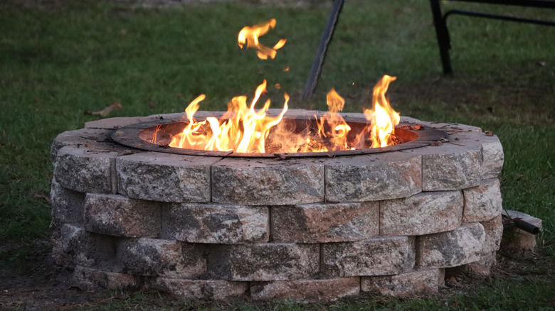 a stone fire pit, blazing