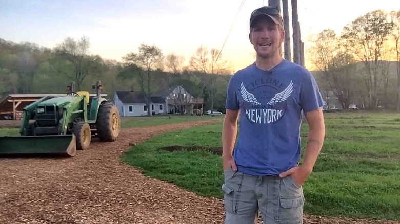 A person showing his new wood-chip driveway