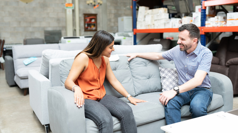 Couple shopping for a sofa in a warehouse store