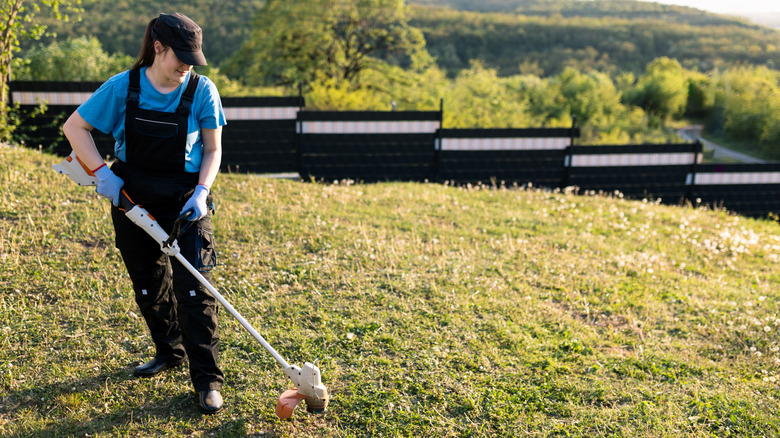Person using a battery string trimmer