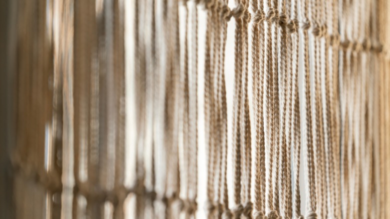 A macramé curtain with simple knots