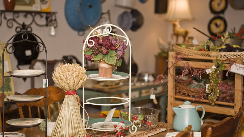 A thrift shop showcasing various kitchen and plate racks including on wall