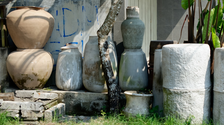 various cement planters in a backyard