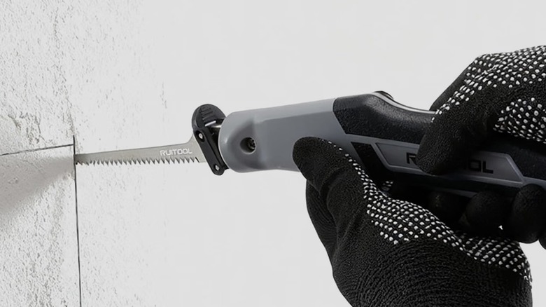Cutting drywall with the Ruitool Multi Blade Hand Saw available from Amazon