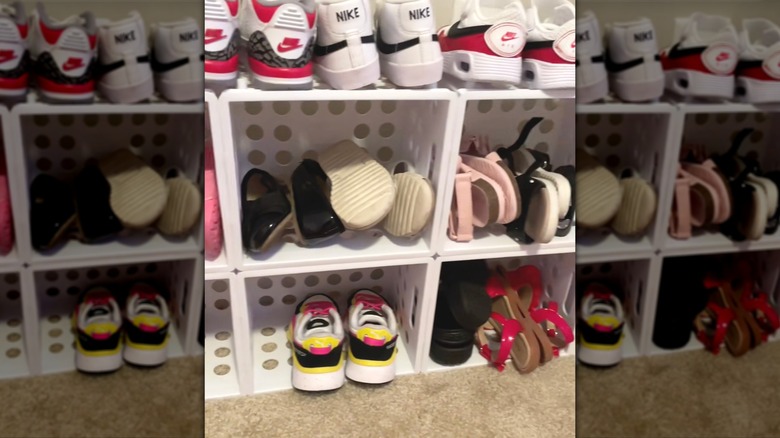 Kids shoe rack built out of plastic mini crates and zip ties.