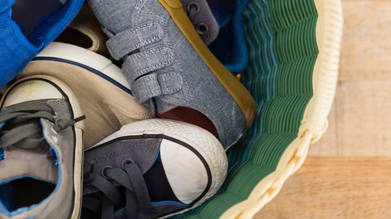 Single basket full of kids shoes tossed together.
