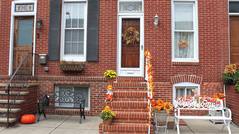 Houses with brick exteriors decorated in an understated manner for Halloween