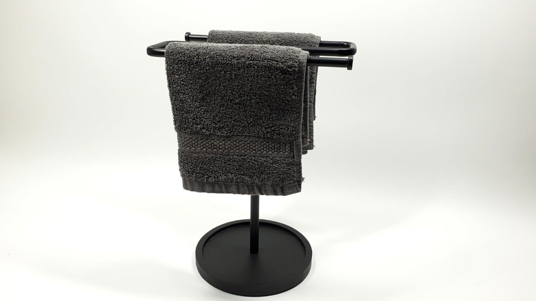 black towel holder in front of white background