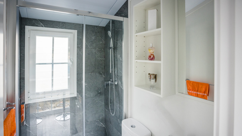 Bathroom with an open shelf on the wall